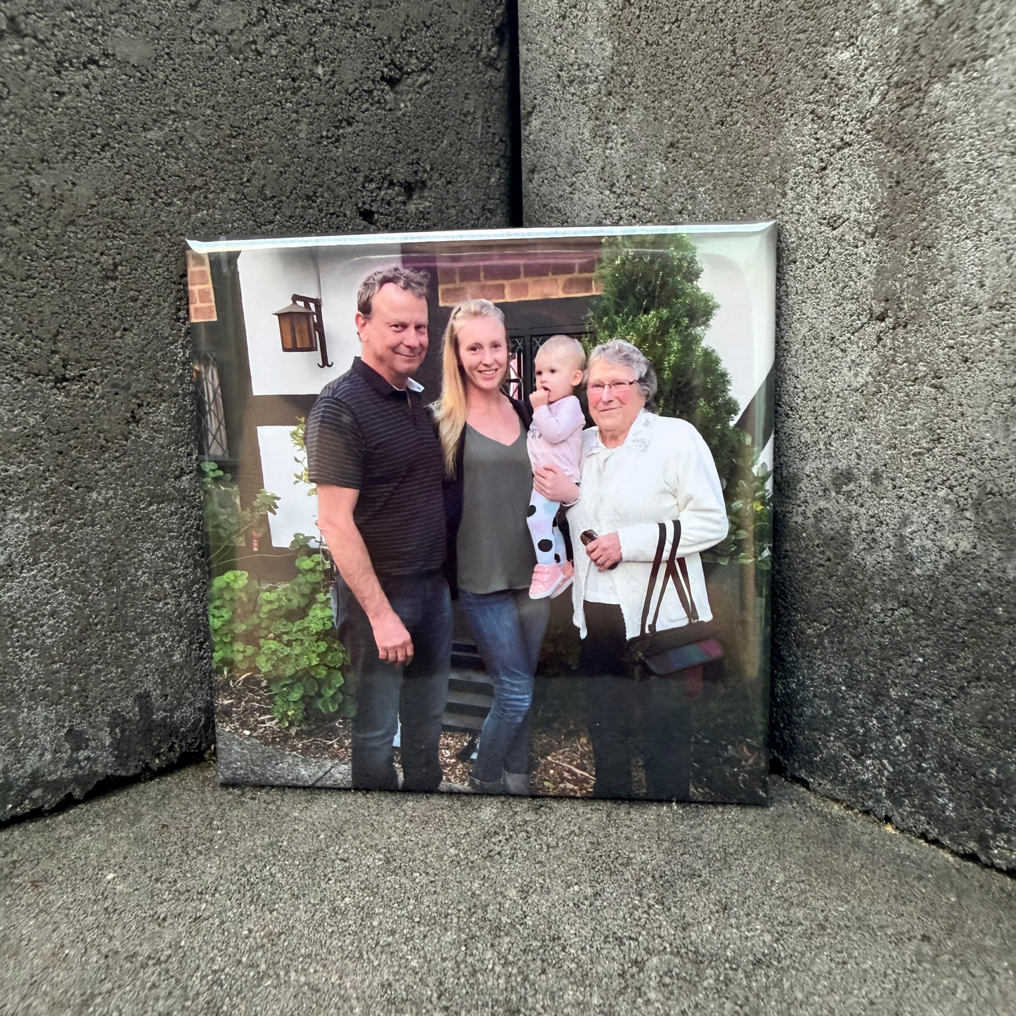 Family photo magnet on a textured stone surface