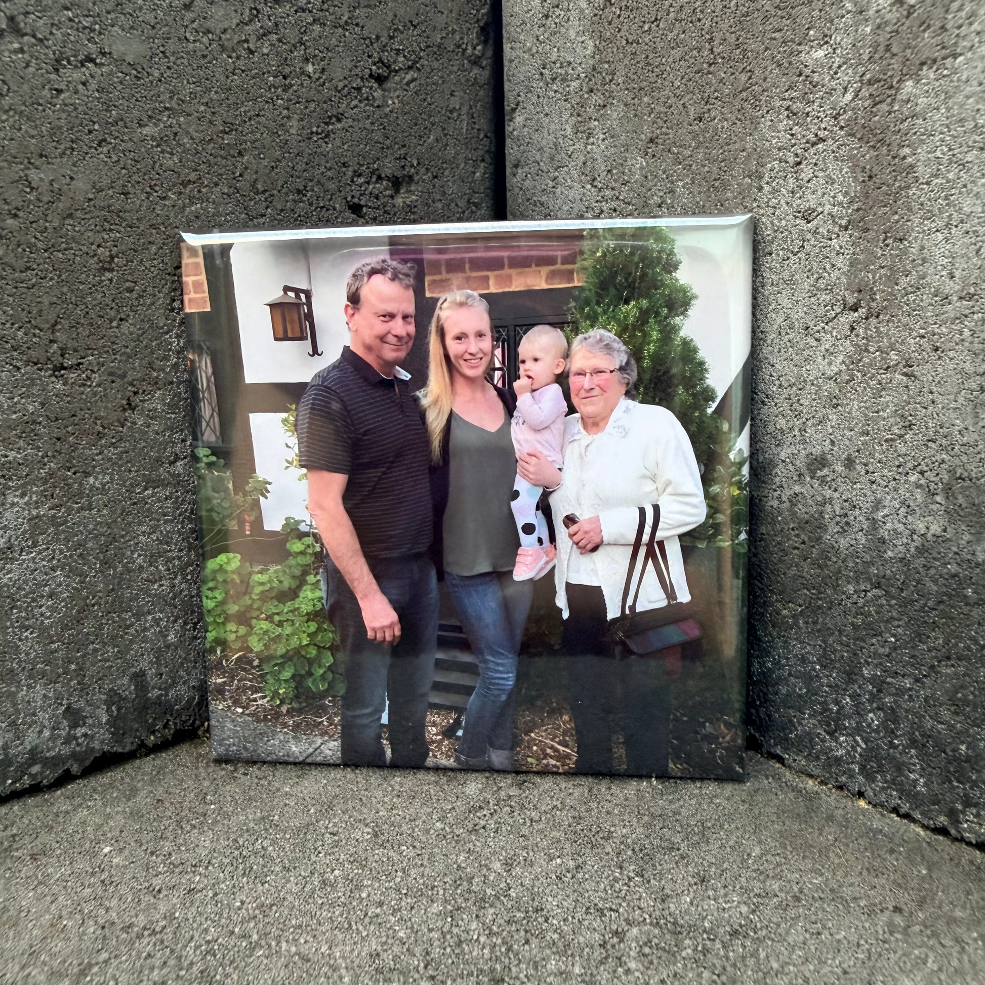Family photo magnet on a textured stone surface